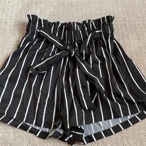 Shein, black flowy shorts with white stripes.